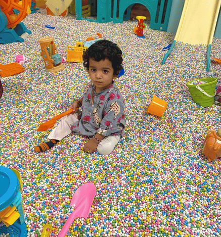 Child enjoying soft play and playing in a colourful ball pit at Wooray Patna.